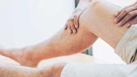 Doctor examining patient's leg